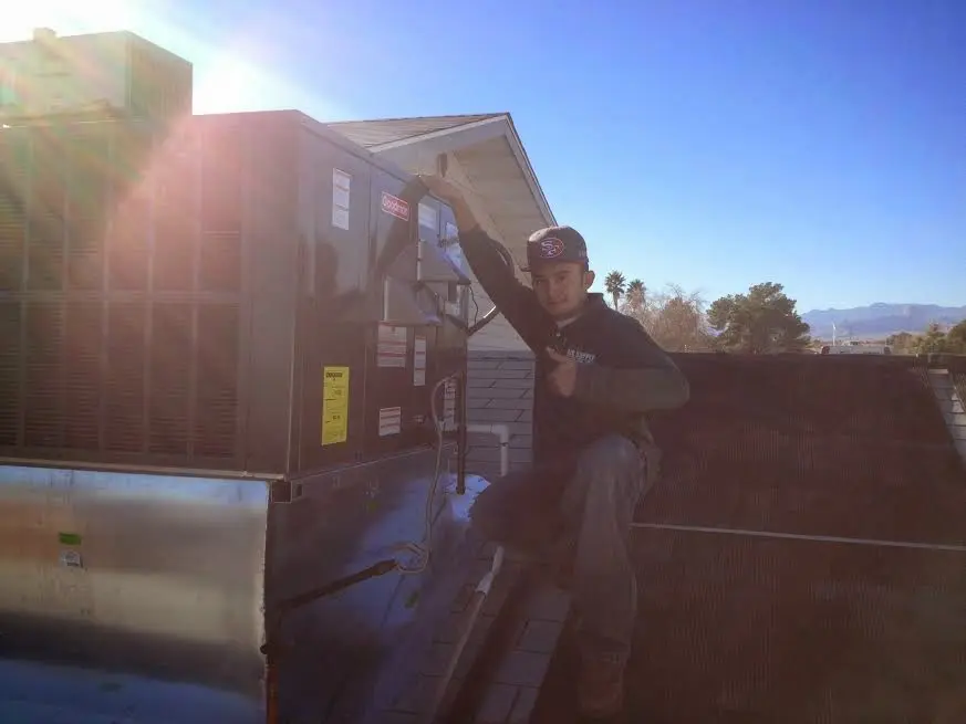 HVAC technician performing Boiler Repair on a rooftop unit in Pimmit Hills